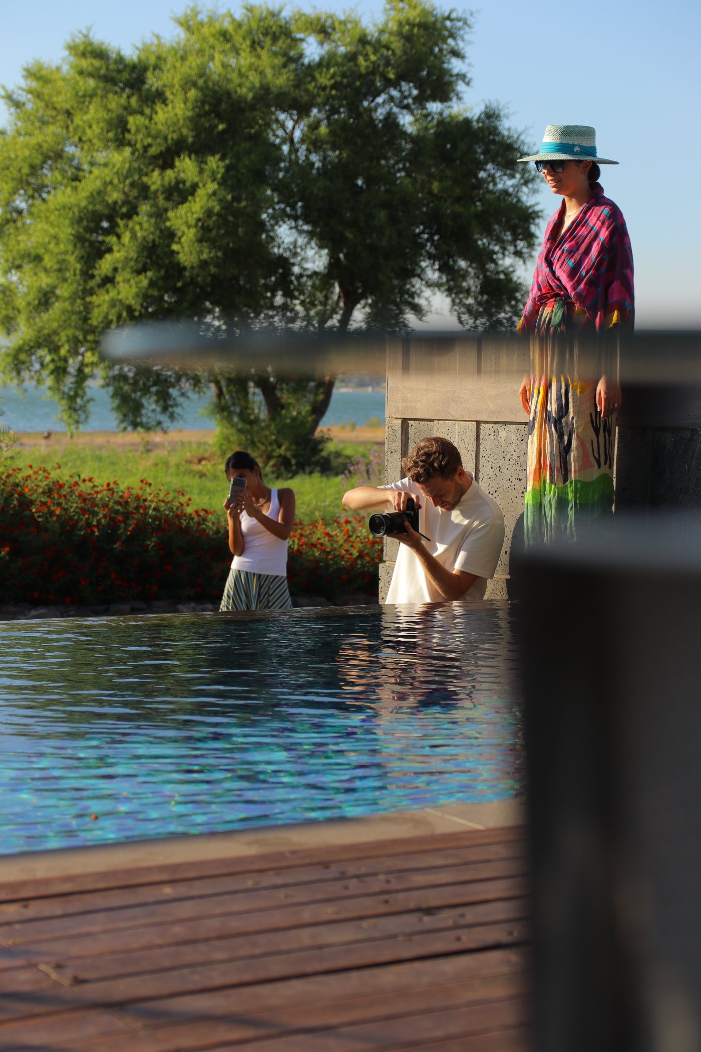 Shooting by the pool, seen through the foliage