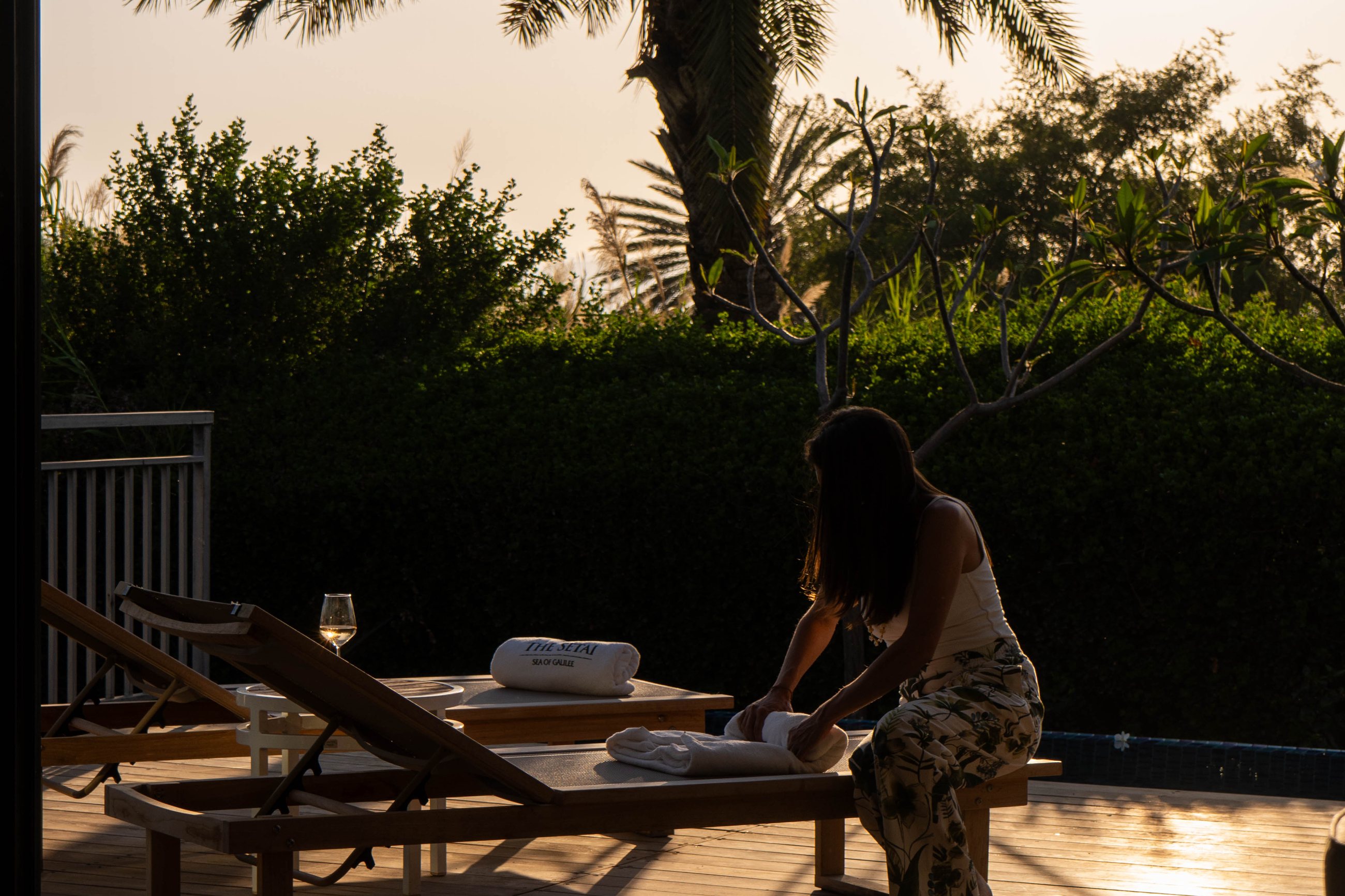 On location at golden hour — setting a lounger before the shot