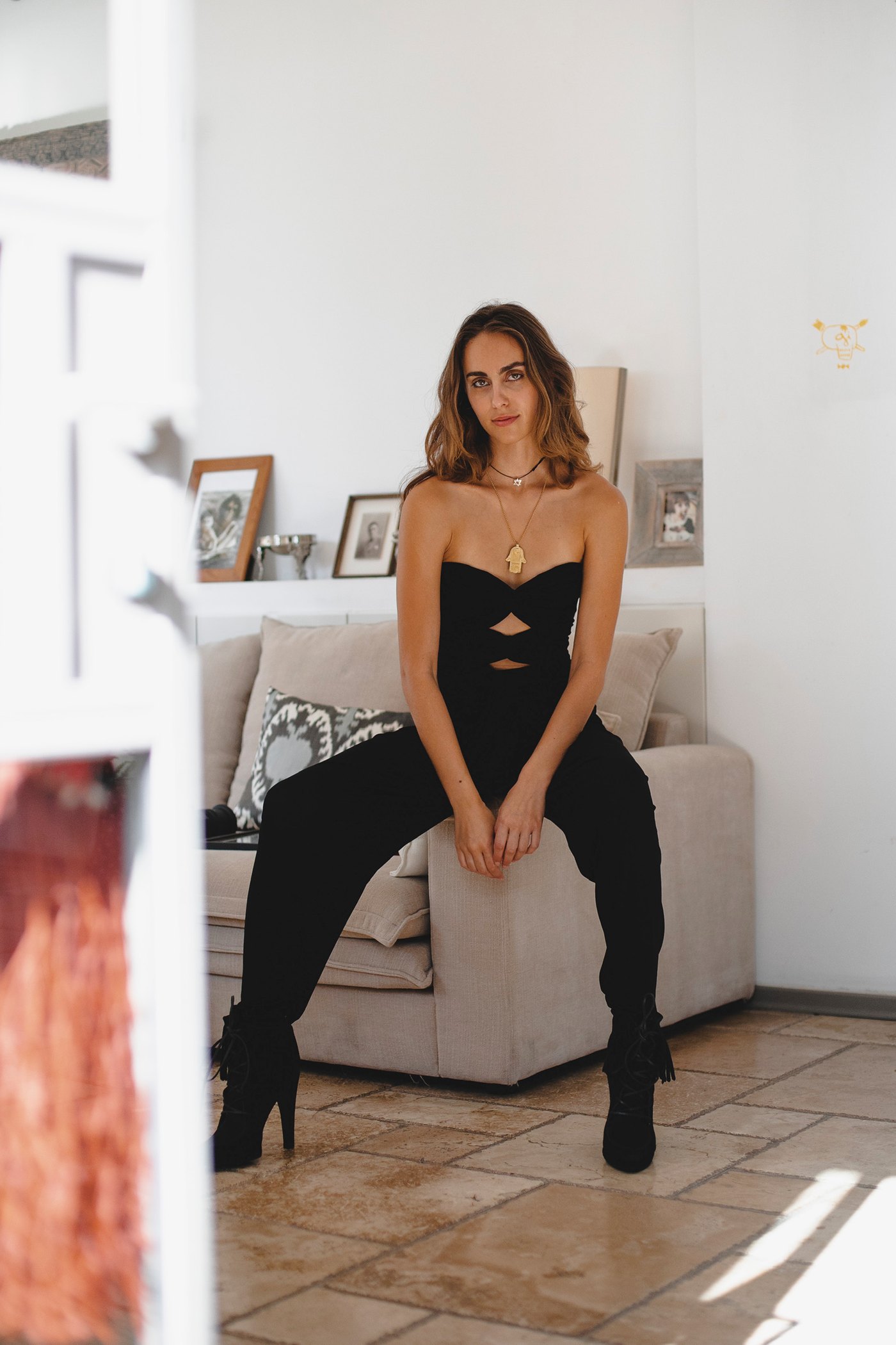 Seated indoors, boots and bustier