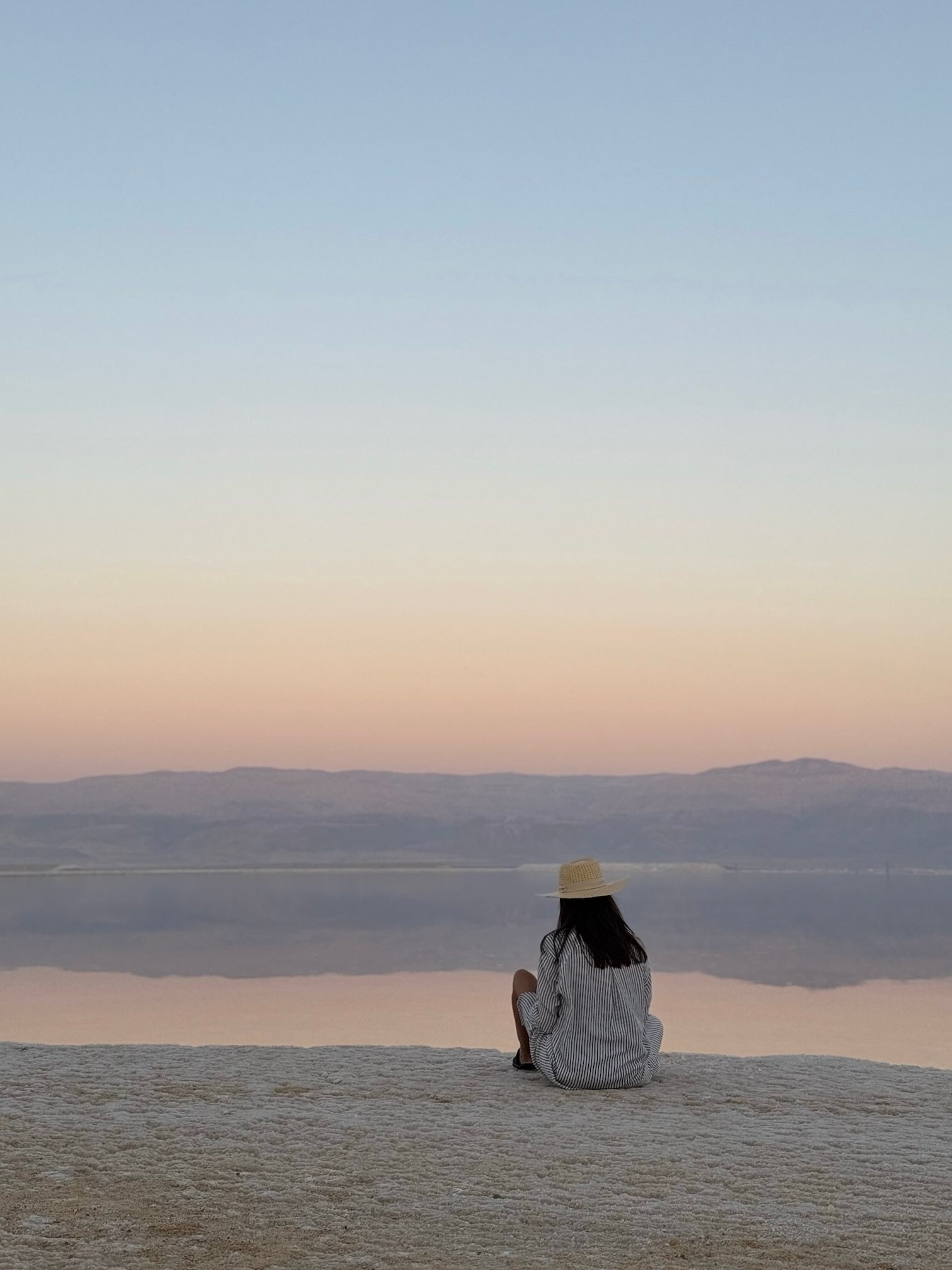 A guest alone at the edge of the Dead Sea