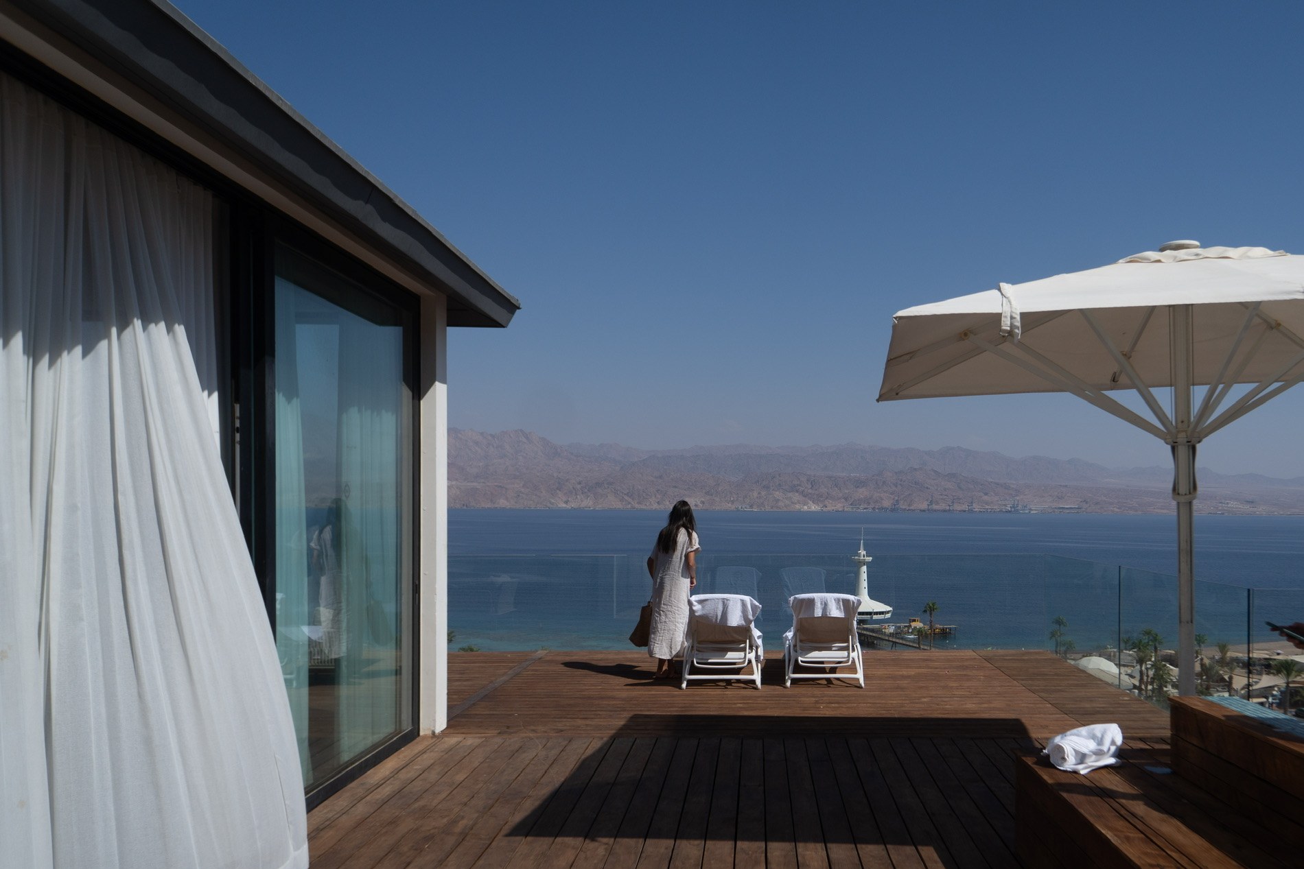 A terrace opening onto the sea, the mountains beyond