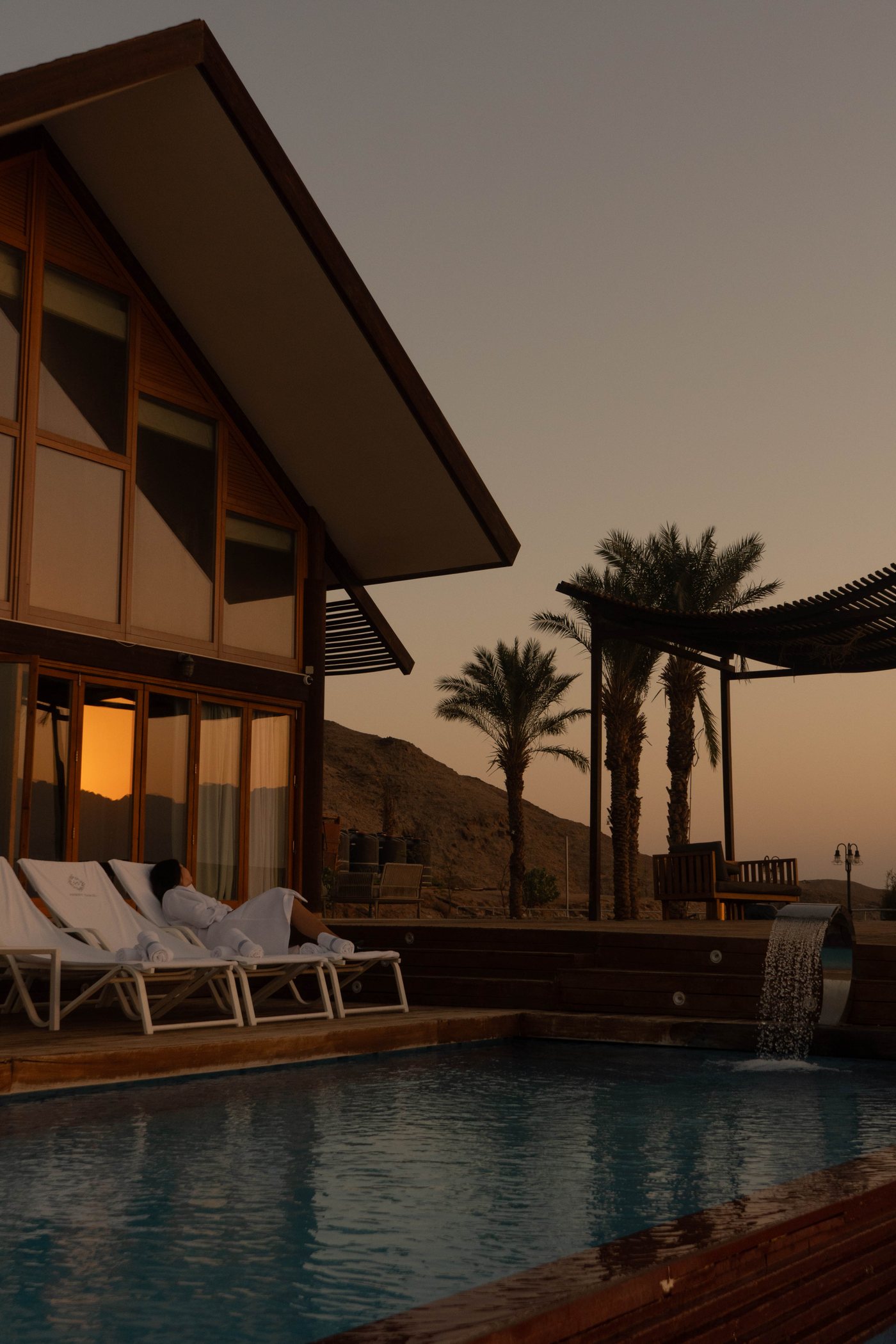 The property at dusk, the pool and the palms