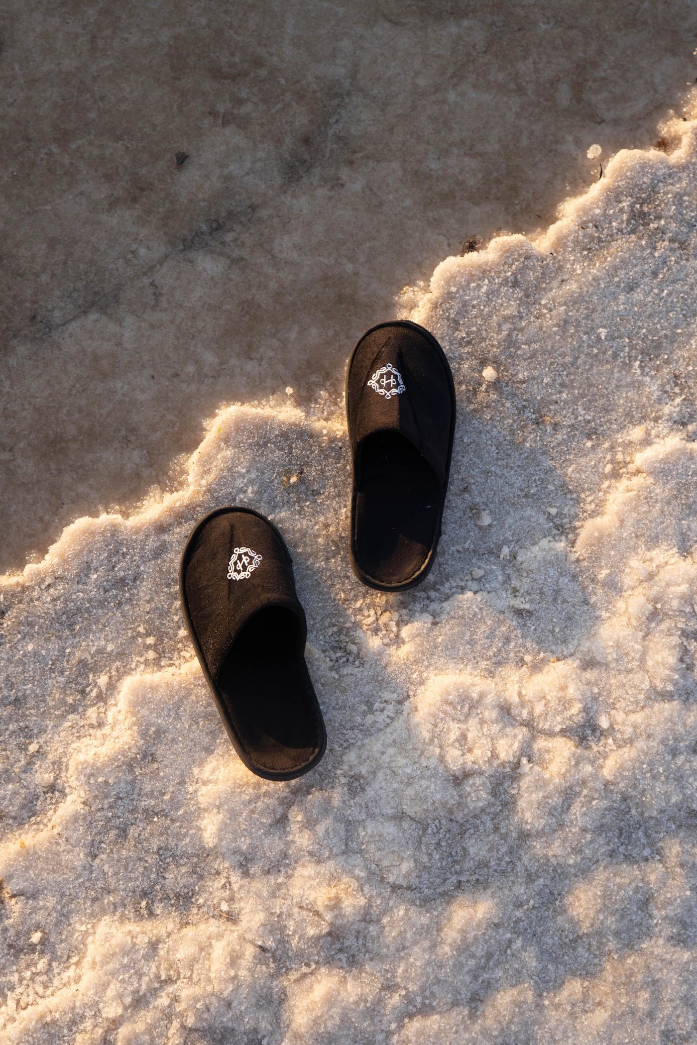 A pair of slippers left on the salt crust
