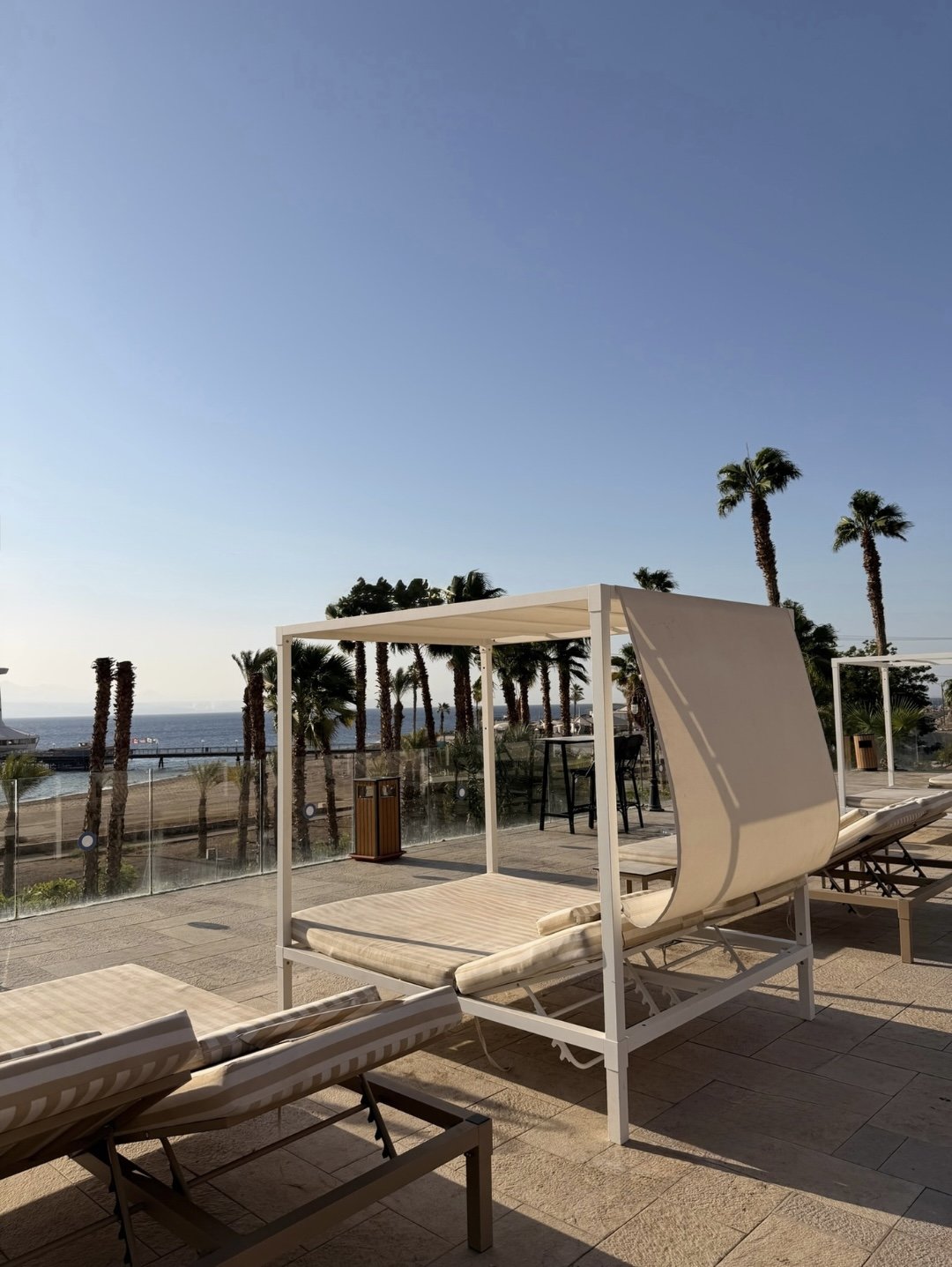 The deck and its loungers above the beach