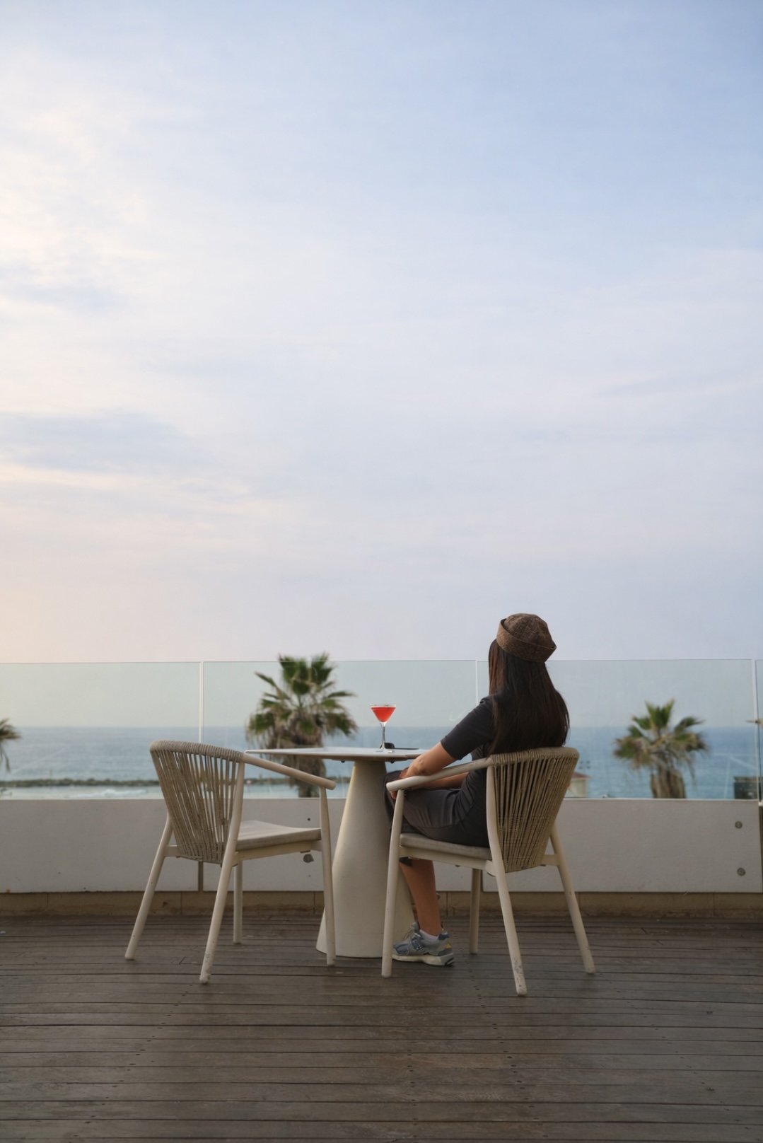 A table on the terrace, the sea below