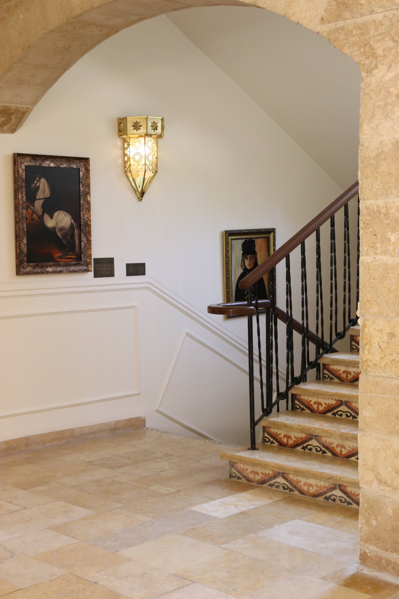 The stairway, its artwork and wall light