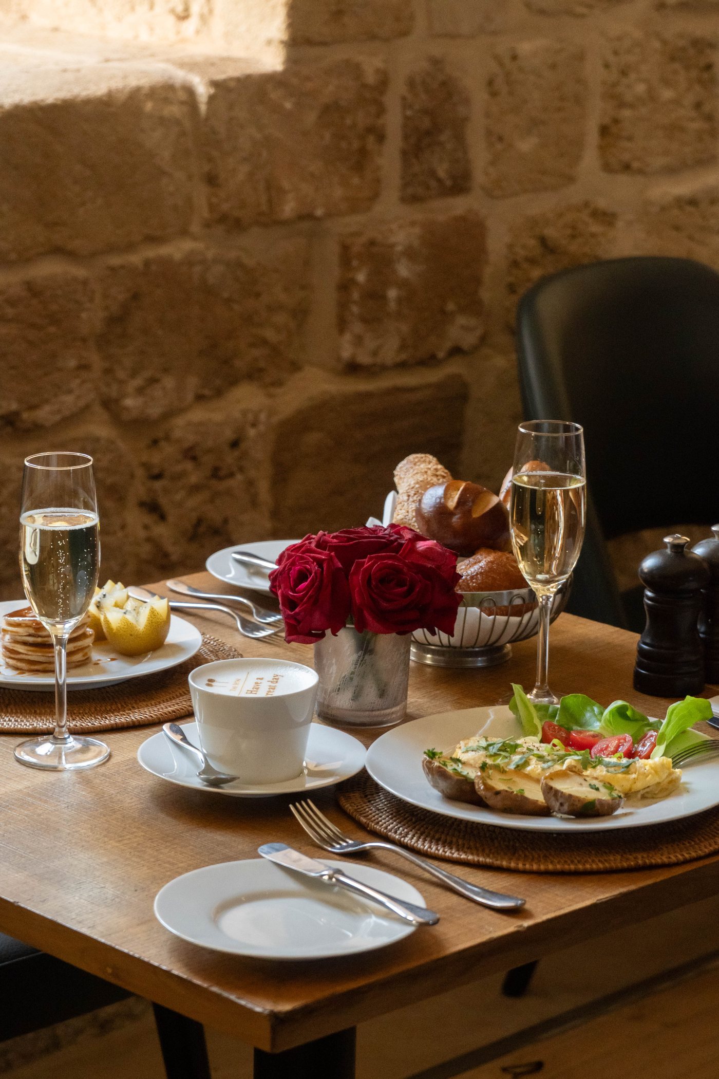 Breakfast, champagne and roses on the table
