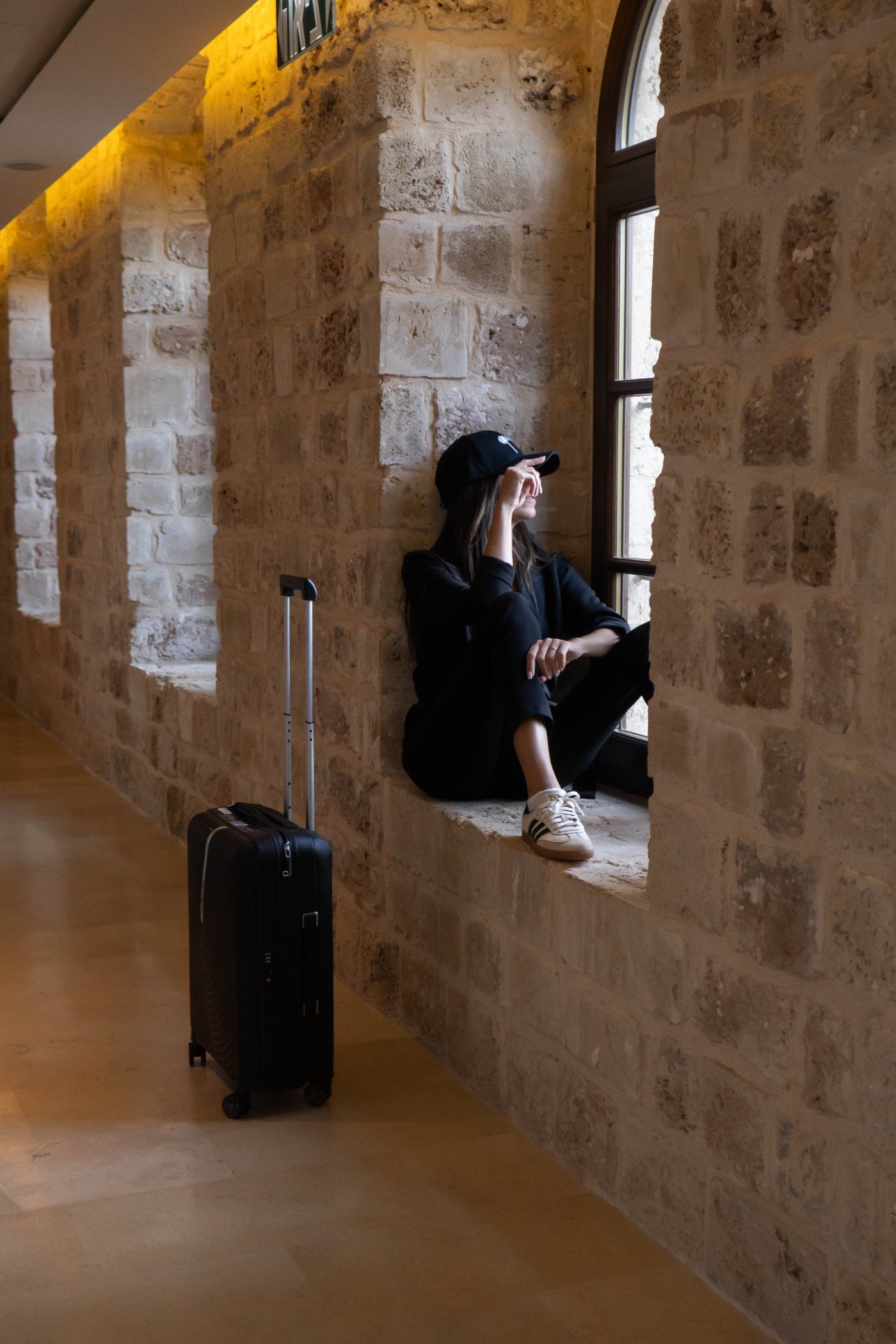 A guest seated in a stone window nook