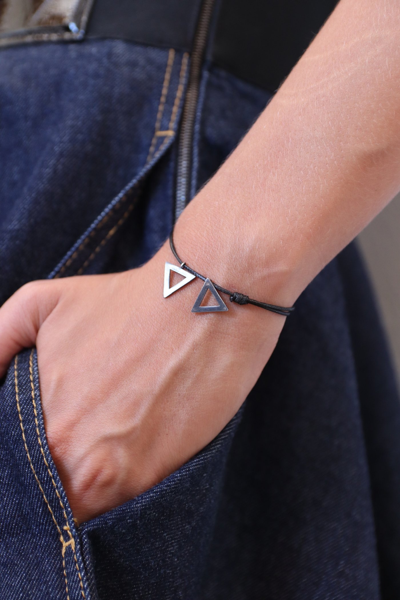 The bracelet at the pocket of the jeans
