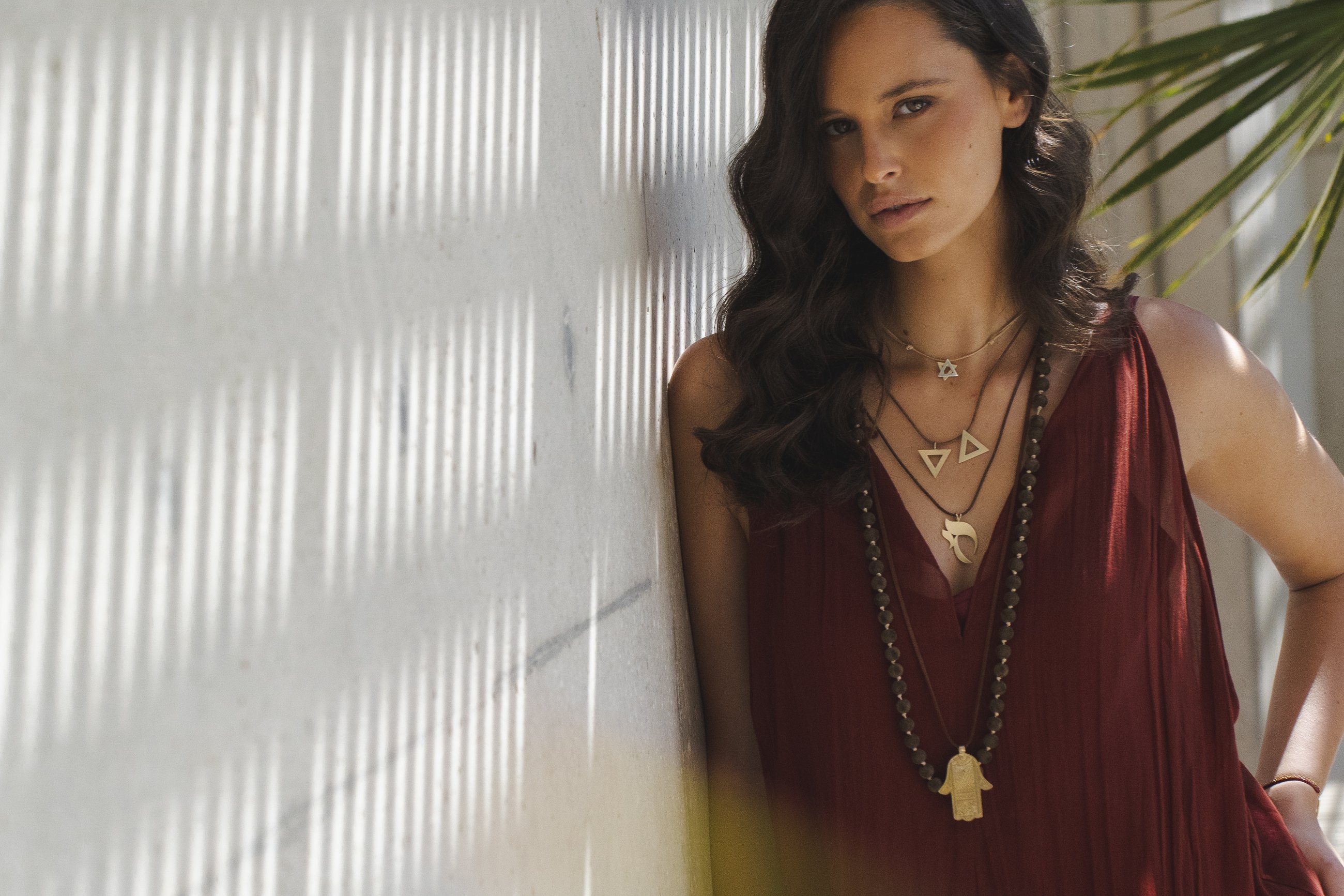 The campaign — the red dress against the shuttered wall