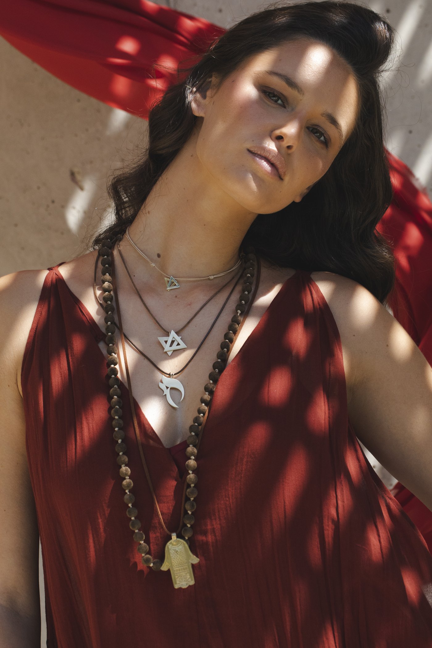 Layered chains, caught in the shade of the palms